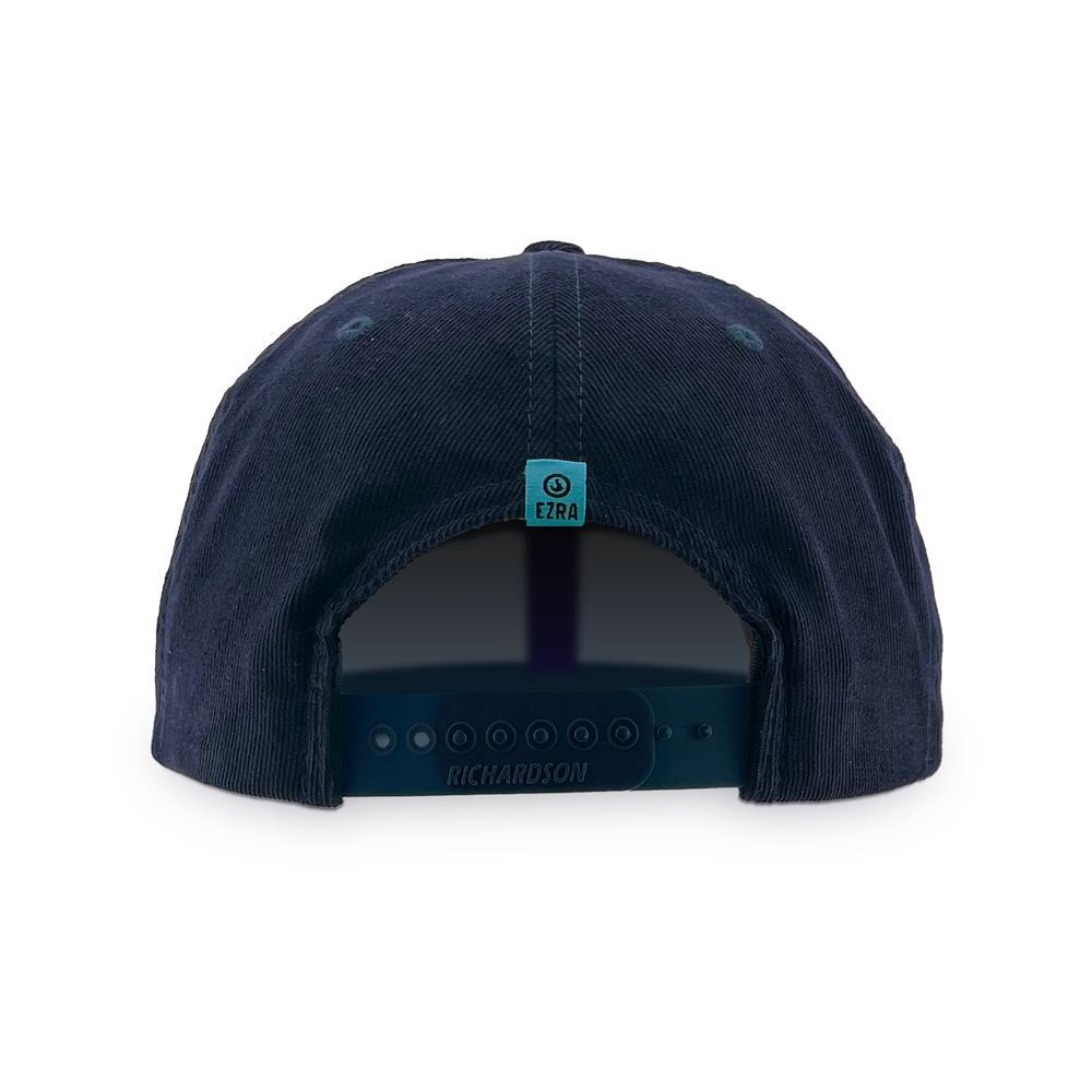 Back of navy blue corduroy cap with an EZRA logo label on the back against a white background