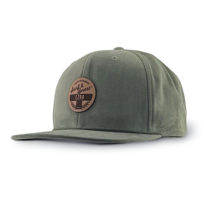 Olive green corduroy cap with a brown leather patch on a white background