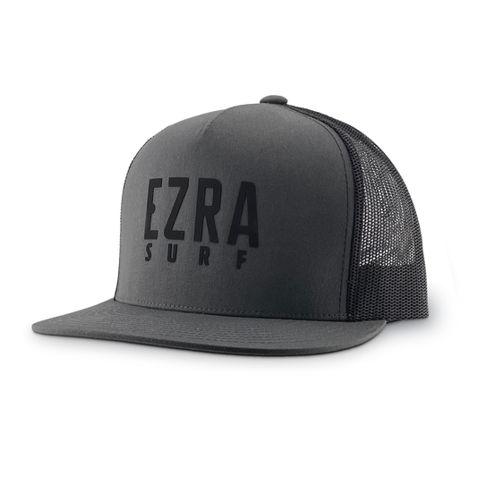 Black and gray trucker cap with 'EZRA SURF' text on a white background