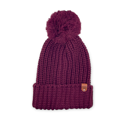 Burgundy color knitted beanie toque with a pom-pom on a white background